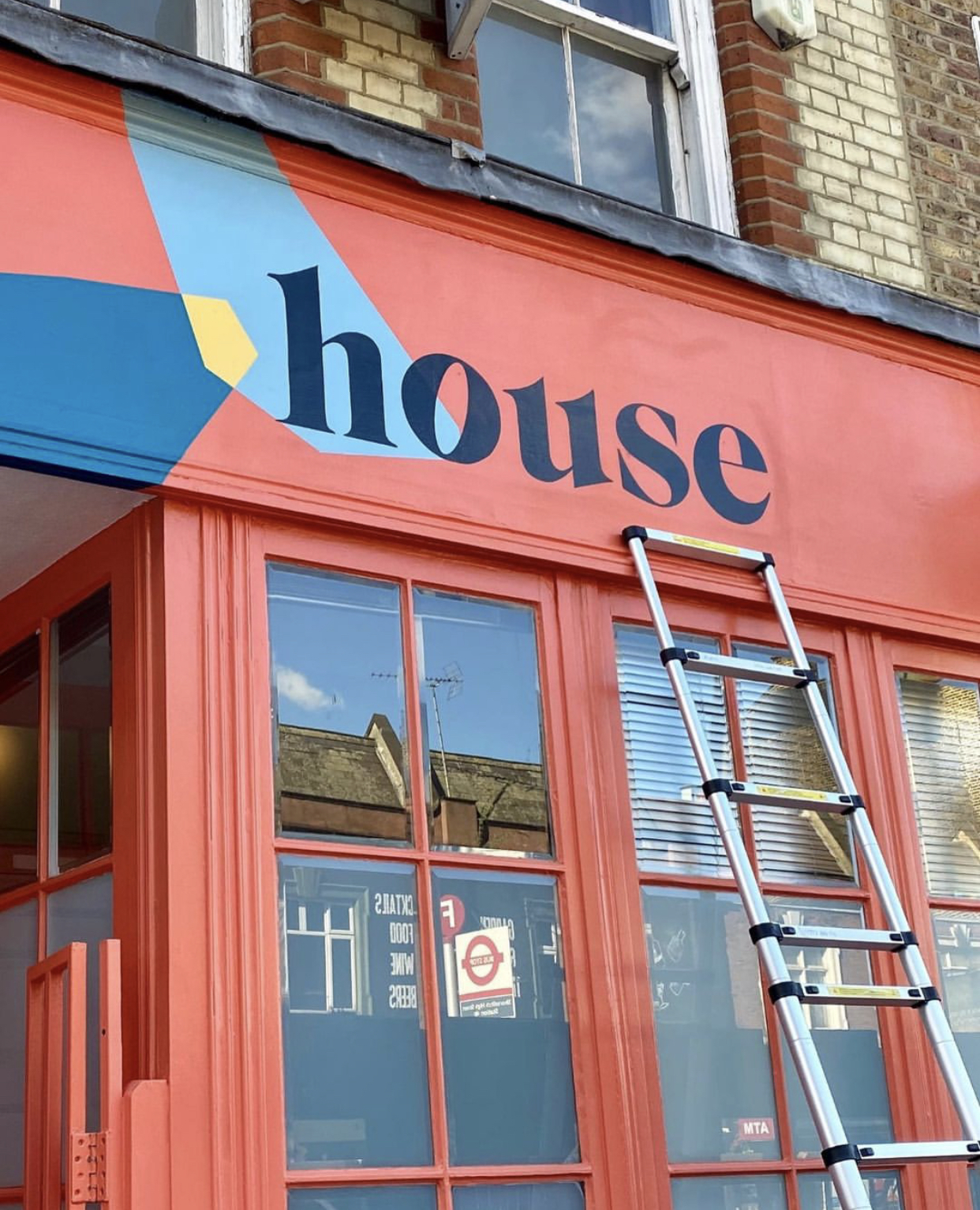 Bespoke, hand-painted business name sign for the House of Creative high street store in London.